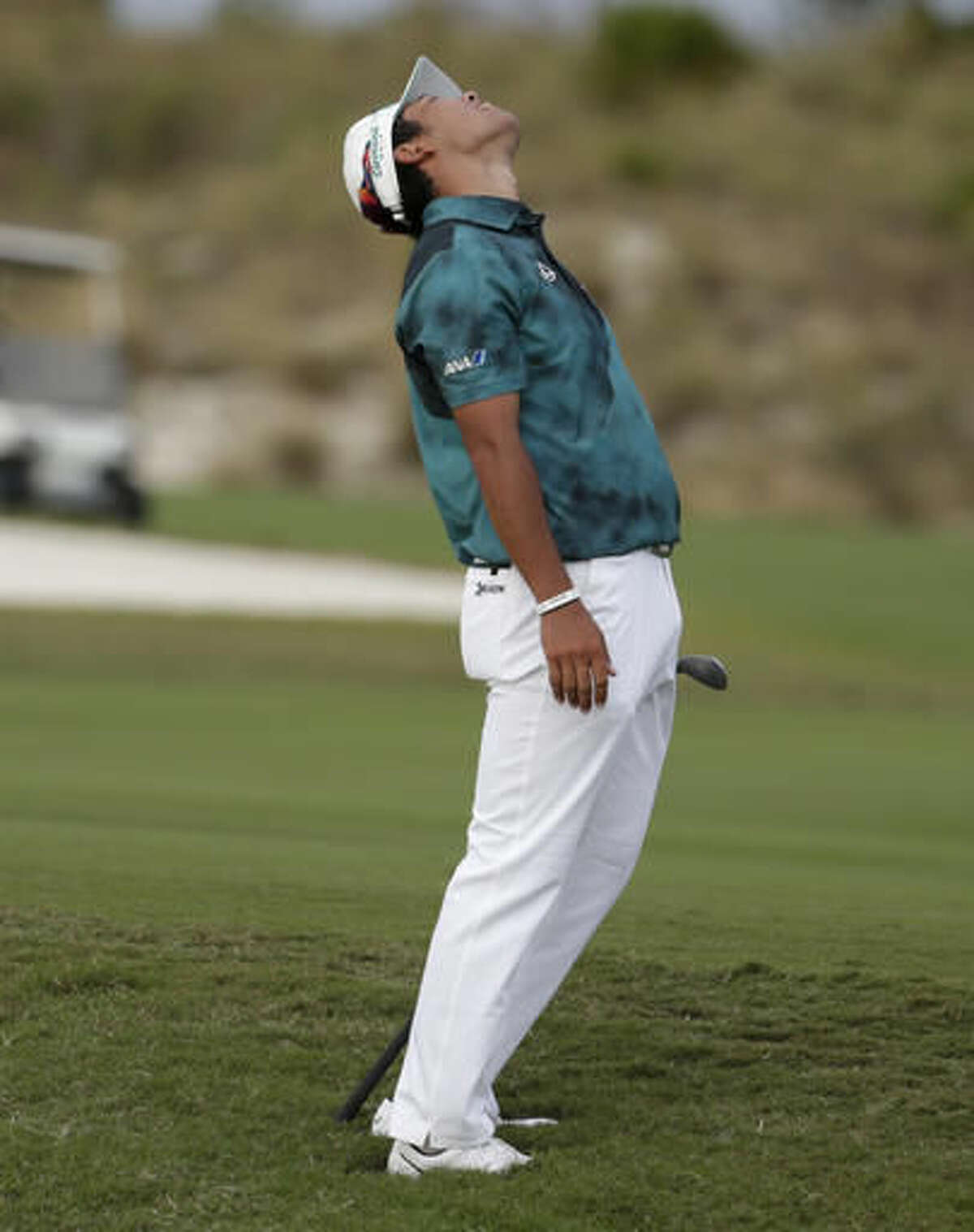 Hideki Matsuyama, of Japan, reacts after hitting from a bunker on the 16th fairway during the third round at the Hero World Challenge golf tournament, Saturday, Dec. 3, 2016, in Nassau, Bahamas. (AP Photo/Lynne Sladky)