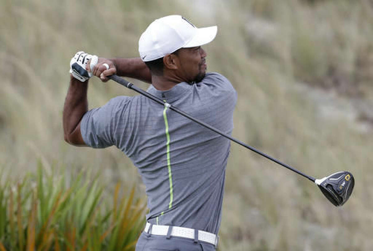 Tiger Woods watches his shot from he third tee during the third round at the Hero World Challenge golf tournament, Saturday, Dec. 3, 2016, in Nassau, Bahamas. (AP Photo/Lynne Sladky)
