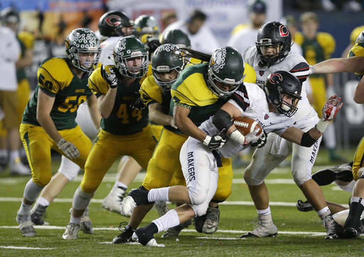 Richland's Dontae Powell, second from right, tackles Camas' Michael Matthews, right, during the first half of the Washington Div. 4A high school football championship, Saturday, Dec. 3, 2016, in Tacoma, Wash. (AP Photo/Ted S. Warren)