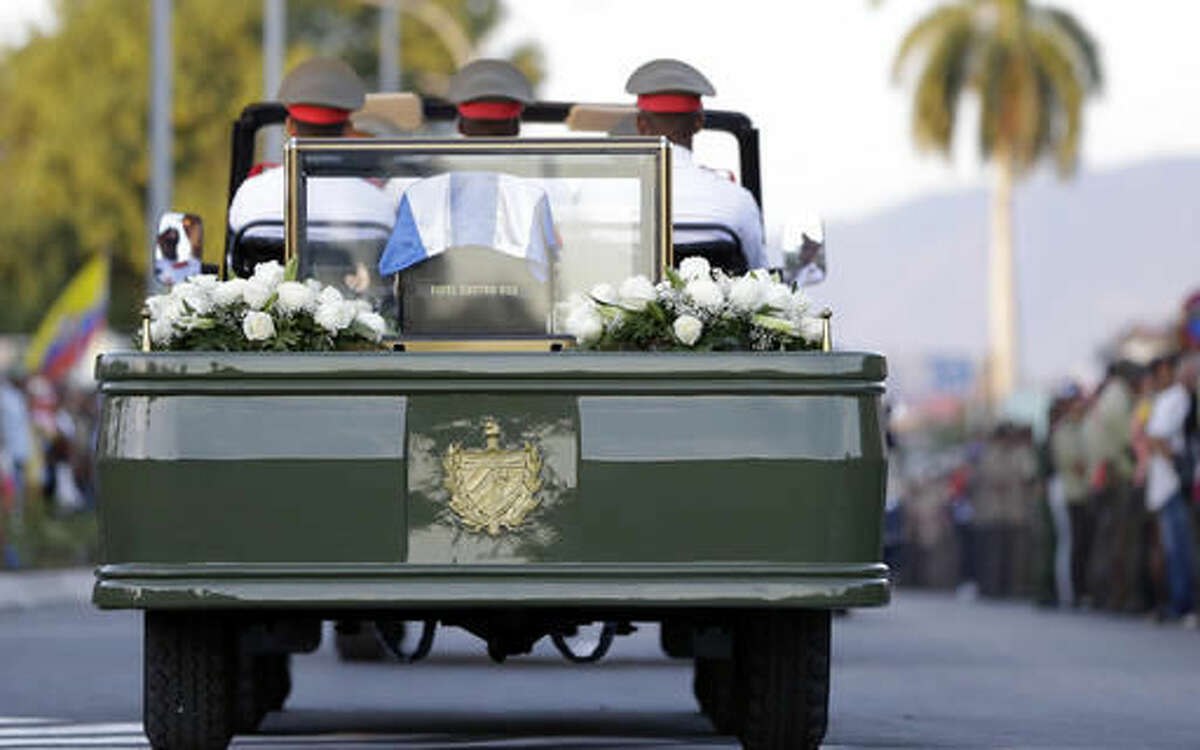 The ashes of Fidel Castro leave the Antonio Maceo plaza for its burial in a private funeral ceremony at the Santa Ifigenia cemetery in Santiago, Cuba Sunday Dec. 4, 2016.(AP Photo/Natacha Pisarenko)