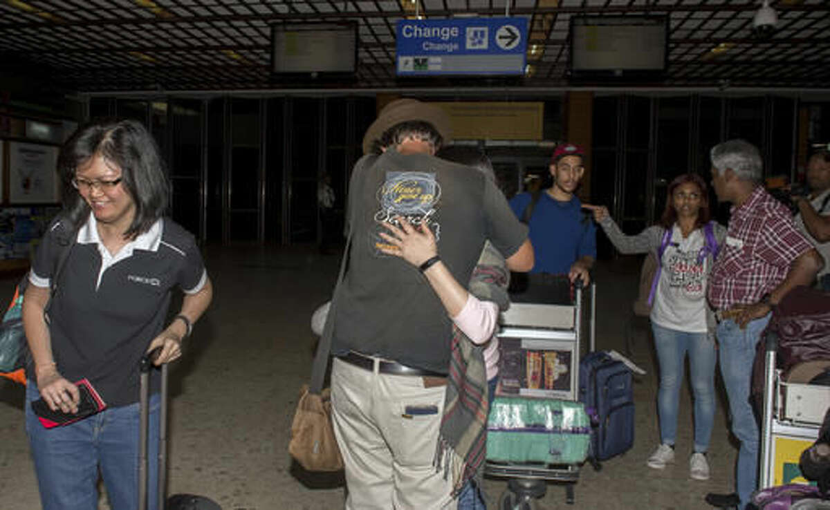 Relatives of passengers of missing Malaysian plane, arrive at the Ivato International Airport in Antananarivo, Madagascar, Saturday, Dec. 3, 2016. Relatives of some of the 239 people who were on a Malaysia Airlines plane that vanished in 2014 have arrived in Madagascar to ask for help in the search for debris from the missing aircraft that may have drifted across the Indian Ocean. (AP Photo/Alexander Joe)