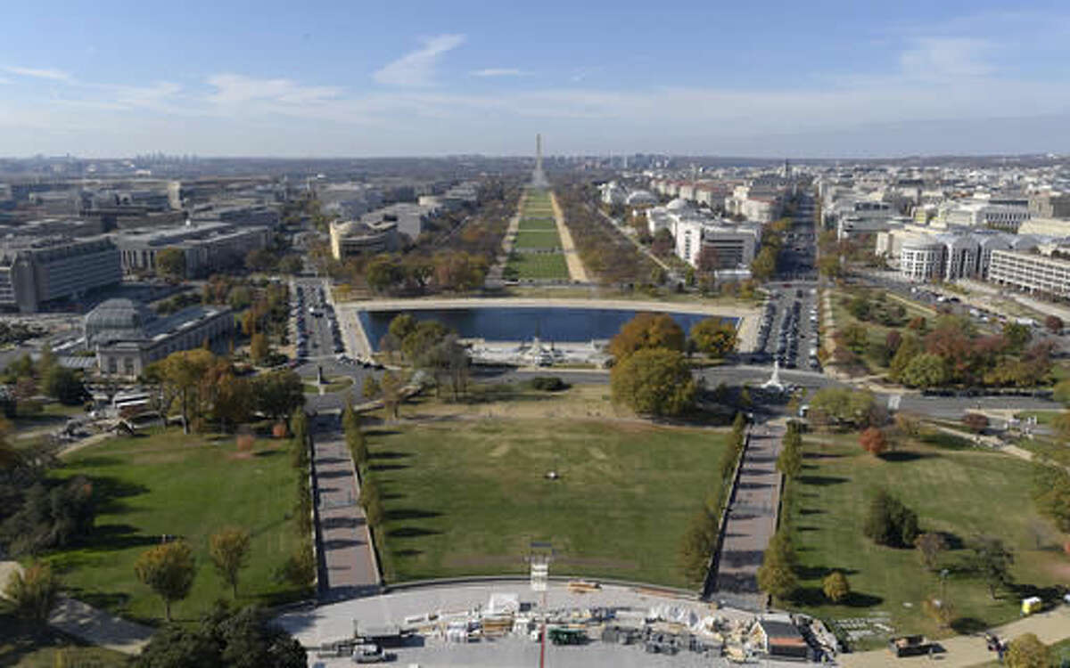 In this Nov. 15, 2016 photo, inaugural preparations continue on the West Front of Capitol Hill in Washington, looking at the National Mall and Washington Monument. One thing you can count on during inauguration season in Washington: People of all stripes will find a reason to show up, whether it’s to celebrate or commiserate. (AP Photo/Susan Walsh)