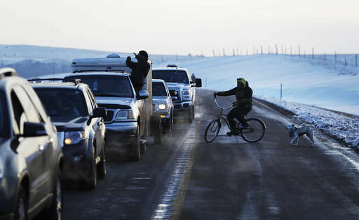 A line of the cars wait to enter the Oceti Sakowin camp where people have gathered to protest the Dakota Access oil pipeline in Cannon Ball, N.D., Saturday, Dec. 3, 2016. (AP Photo/David Goldman)