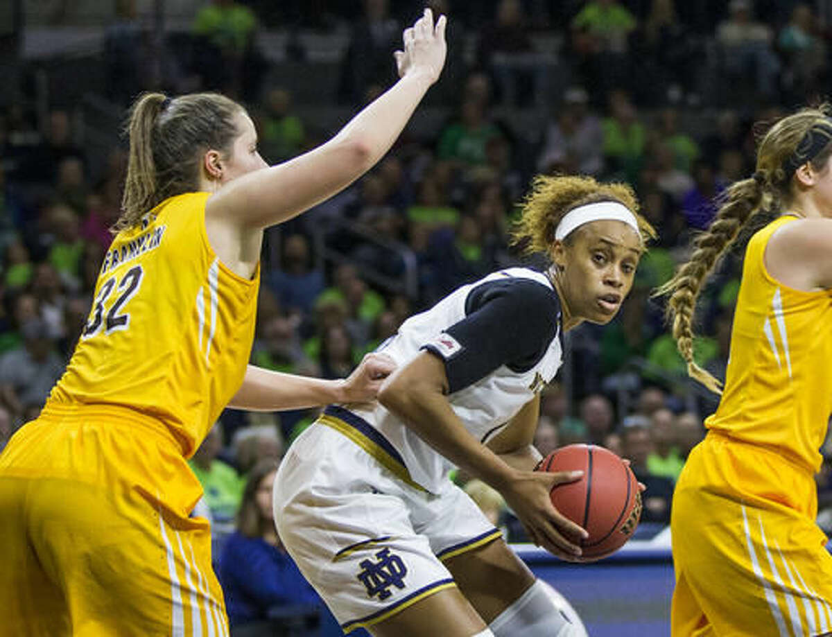 Notre Dame's Brianna Turner, center, is pressured by Valparaiso's Dani Franklin (32) during the second half of an NCAA college basketball game Sunday, Dec. 4, 2016, in South Bend, Ind. (AP Photo/Robert Franklin)