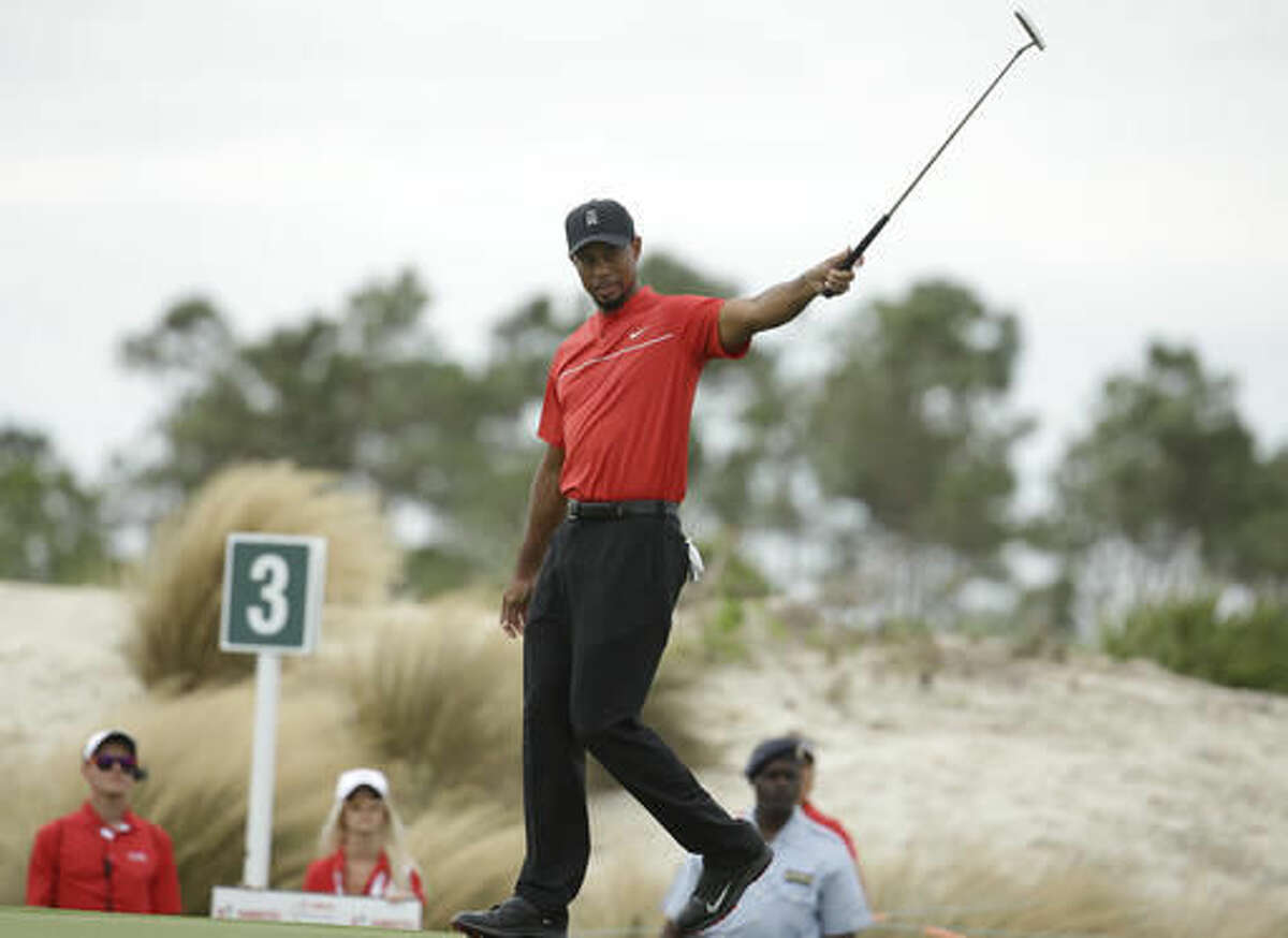 Tiger Woods reacts after putting on the third hole during the final round at the Hero World Challenge golf tournament, Sunday, Dec. 4, 2016, in Nassau, Bahamas. (AP Photo/Lynne Sladky)