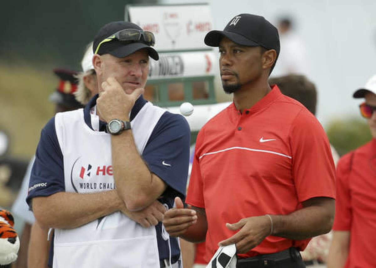 Tiger Woods waits with his caddie, Joe LaCava, to tee off on the second hole during the final round at the Hero World Challenge golf tournament, Sunday, Dec. 4, 2016, in Nassau, Bahamas. (AP Photo/Lynne Sladky)