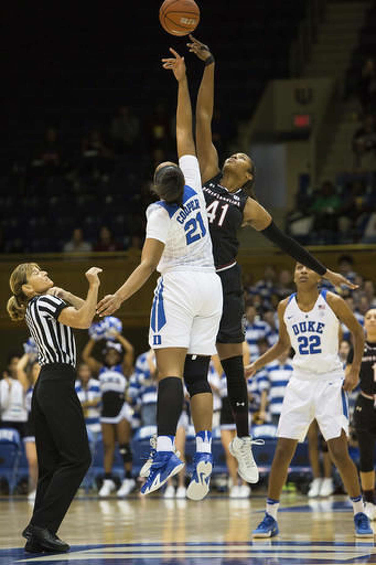 Duke's Kendall Cooper (21) and South Carolina's Alaina Coates (41) tip-off at the start of an NCAA college basketball game in Durham, N.C., Sunday, Dec. 4, 2016. (AP Photo/Ben McKeown)