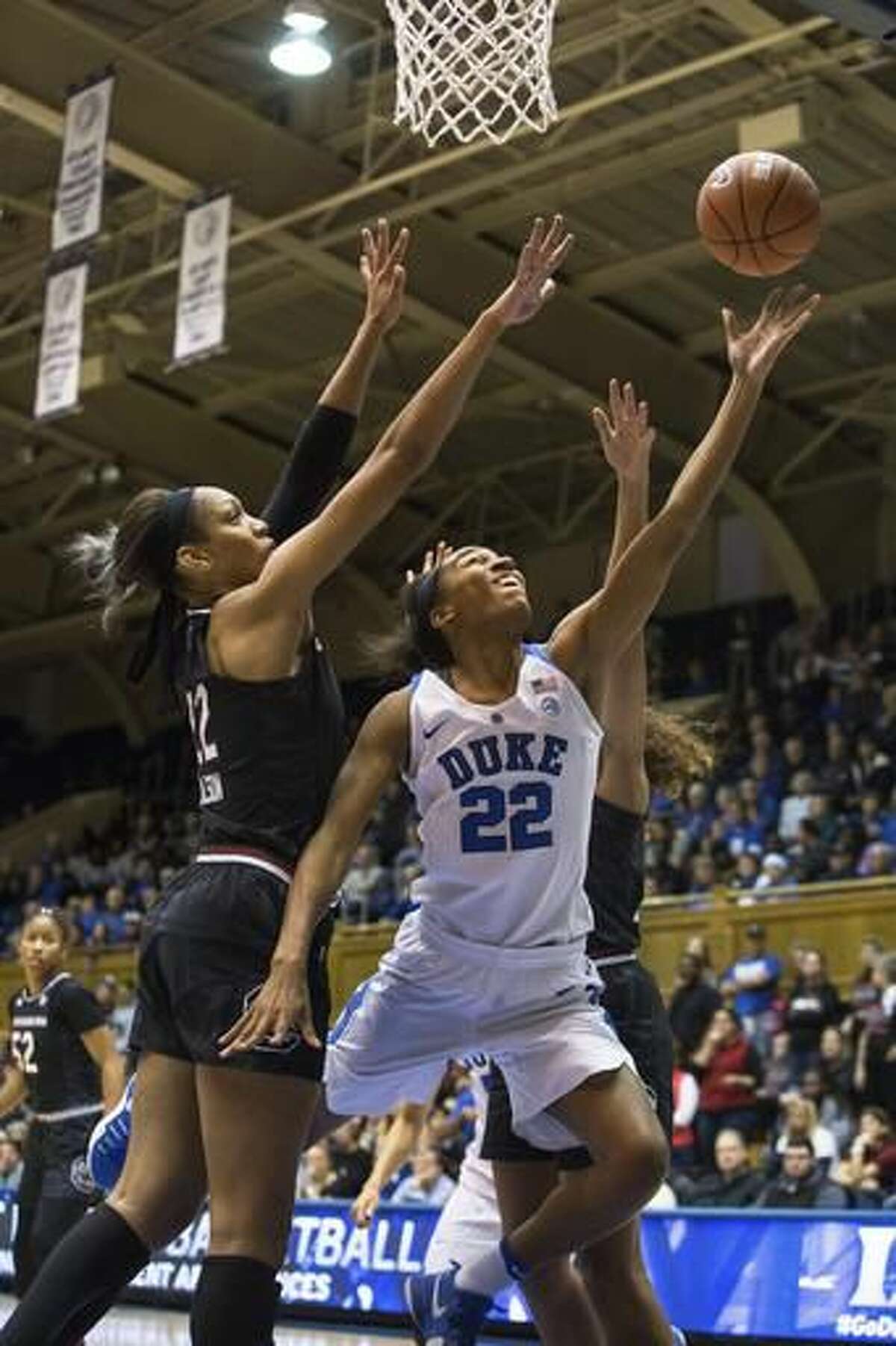Duke's Oderah Chidom (22) attempts a basket as South Carolina's A'ja Wilson (22) defends during the first half of an NCAA college basketball game in Durham, N.C., Sunday, Dec. 4, 2016. (AP Photo/Ben McKeown)