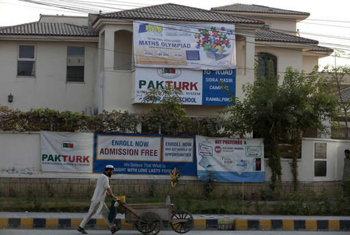 A Pakistani vendor walks past the Rawalpindi campus of Pak-Turk school in Pakistan, Wednesday, Nov. 16, 2016. akistan has ordered 400 Turk nationals associated with the Pak-Turk International chain of schools and colleges to leave the country in the next 72 hours, says a statement on the school's website. The deportation order comes as Turkish President Erdogan is to arrive in Islamabad on a two-day visit to discuss bilateral, International and regional issues with Pakistani leadership. (AP Photo/B.K. Bangash)