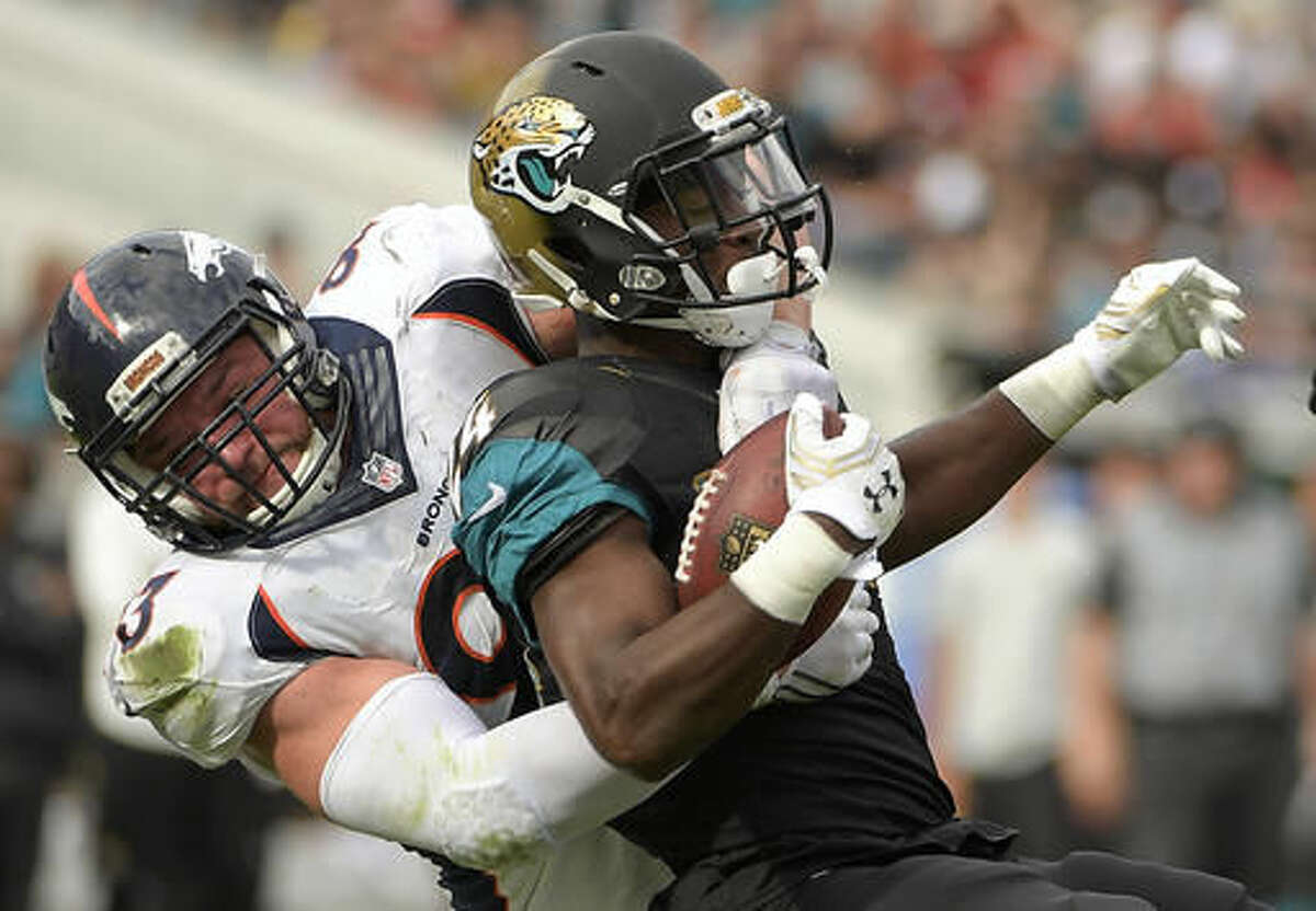 Jacksonville Jaguars running back T.J. Yeldon, right, is stopped by Denver Broncos defensive end Jared Crick during the first half of an NFL football game in Jacksonville, Fla., Sunday, Dec. 4, 2016. (AP Photo/Phelan M. Ebenhack)