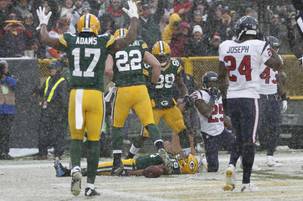 Green Bay Packers' Randall Cobb does a snow angel after catching a touchdown pass during the first half of an NFL football game against the Houston Texans Sunday, Dec. 4, 2016, in Green Bay, Wis. (AP Photo/Mike Roemer)