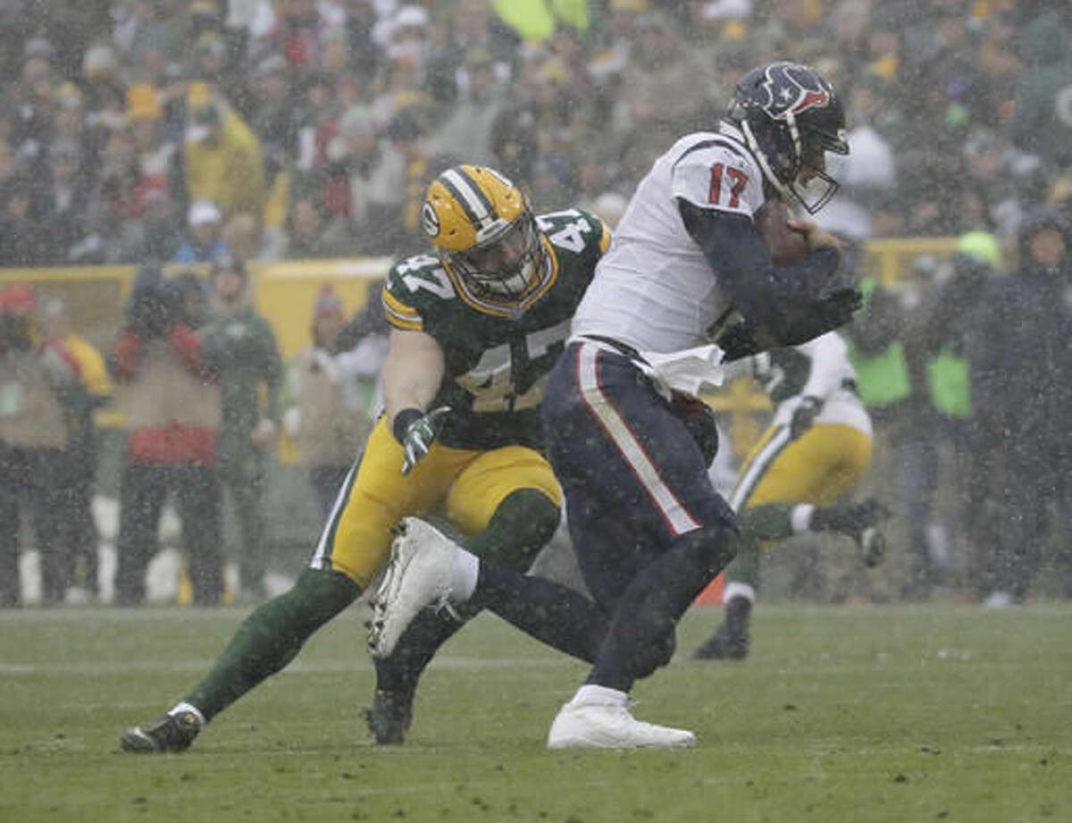 Houston Texans' Brock Osweiler runs away from Green Bay Packers' Jake Ryan during the first half of an NFL football game Sunday, Dec. 4, 2016, in Green Bay, Wis. (AP Photo/Morry Gash)