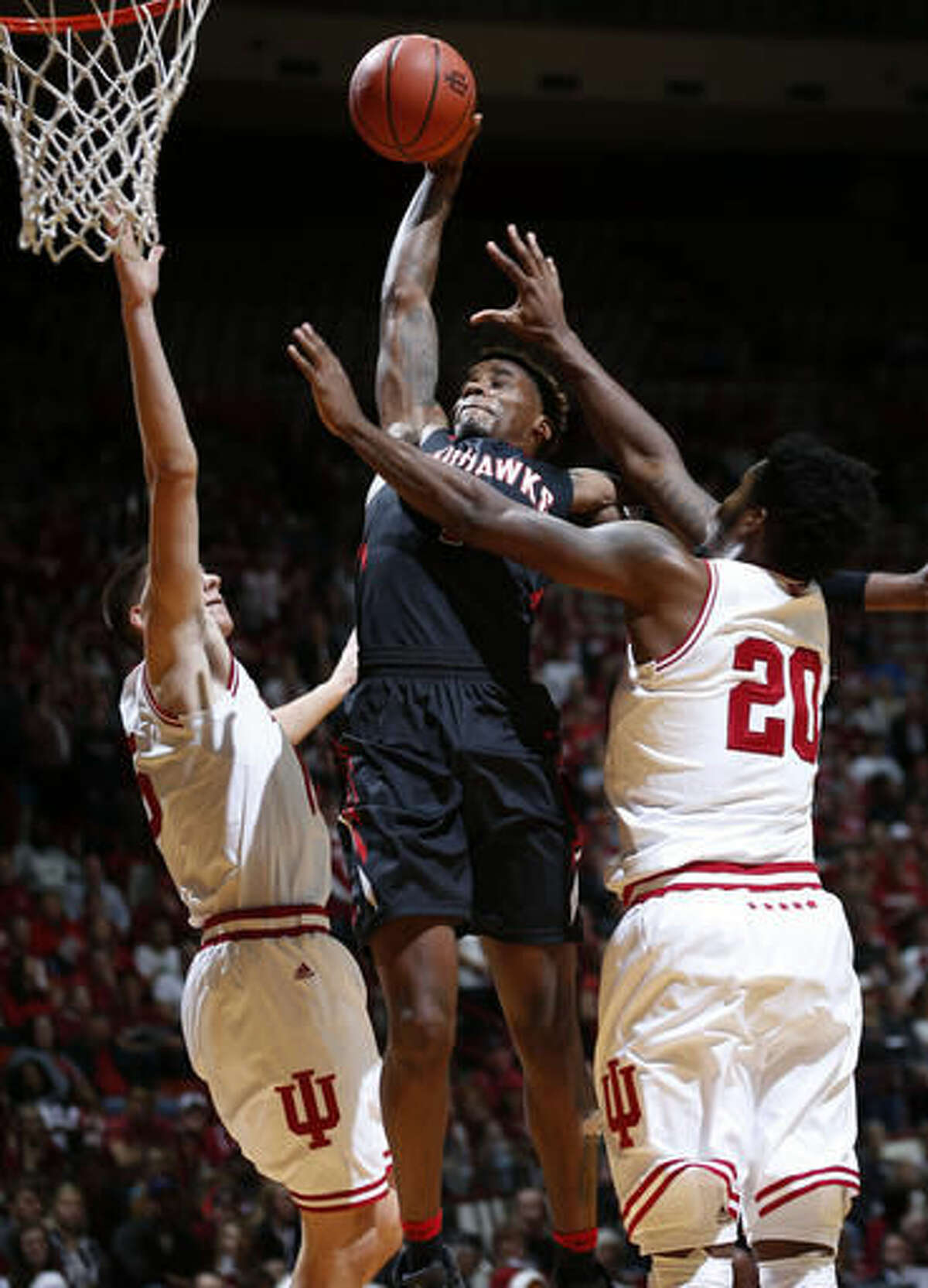 Southeast Missouri guard Antonius Cleveland, center, dunks between Indiana defenders Zach McRoberts, left, and De'Ron Davis in the first half of an NCAA college basketball game in Bloomington, Ind., Sunday, Dec. 4, 2016. (AP Photo/AJ Mast)