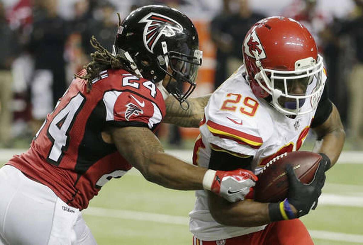Kansas City Chiefs strong safety Eric Berry (29) breaks the tackle of Atlanta Falcons running back Devonta Freeman (24) after Berry made an interception during the first half of an NFL football game, Sunday, Dec. 4, 2016, in Atlanta. Berry scored a touchdown on the play(AP Photo/Chuck Burton)