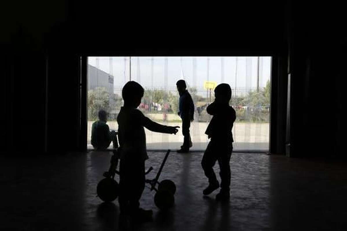 Children play inside a building at the Kalochori refugee camp, set up in a disused supermarket, on the outskirts of the northern Greek city of Thessaloniki on Tuesday, Nov. 8, 2016. More than 60,000 refugees are stranded in Greece, unable to continue their journeys northward to more prosperous European Union countries after Balkan countries shut down their land borders to refugees earlier this year. (AP Photo/Thanassis Stavrakis)