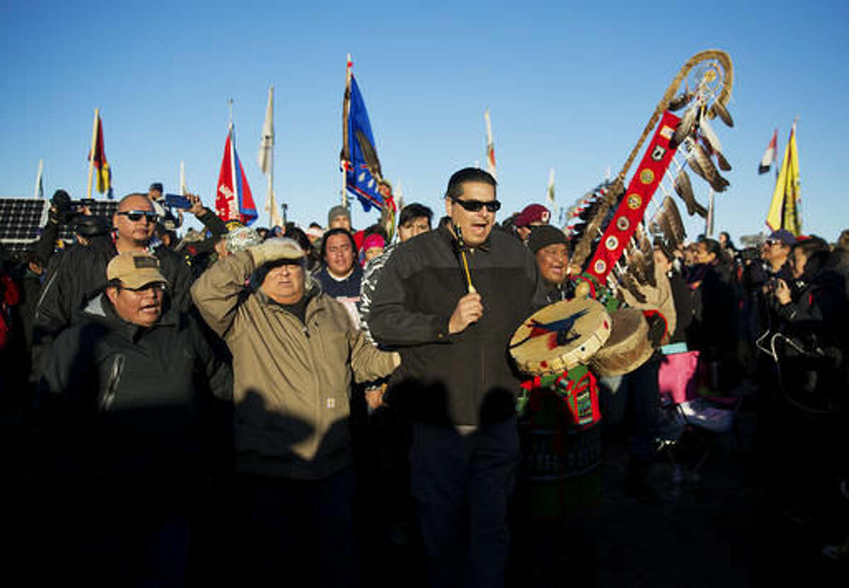 A Native American drum procession moves through the Oceti Sakowin camp after it was announced that the U.S. Army Corps of Engineers won't grant easement for the Dakota Access oil pipeline in Cannon Ball, N.D., Sunday, Dec. 4, 2016. (AP Photo/David Goldman)