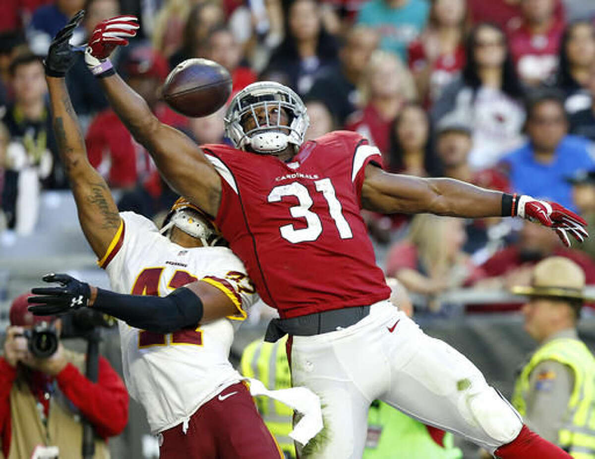 Arizona Cardinals running back David Johnson (31) can't make the catch as Washington Redskins free safety Will Blackmon (41) defends during the second half of an NFL football game, Sunday, Dec. 4, 2016, in Glendale, Ariz. (AP Photo/Ross D. Franklin)