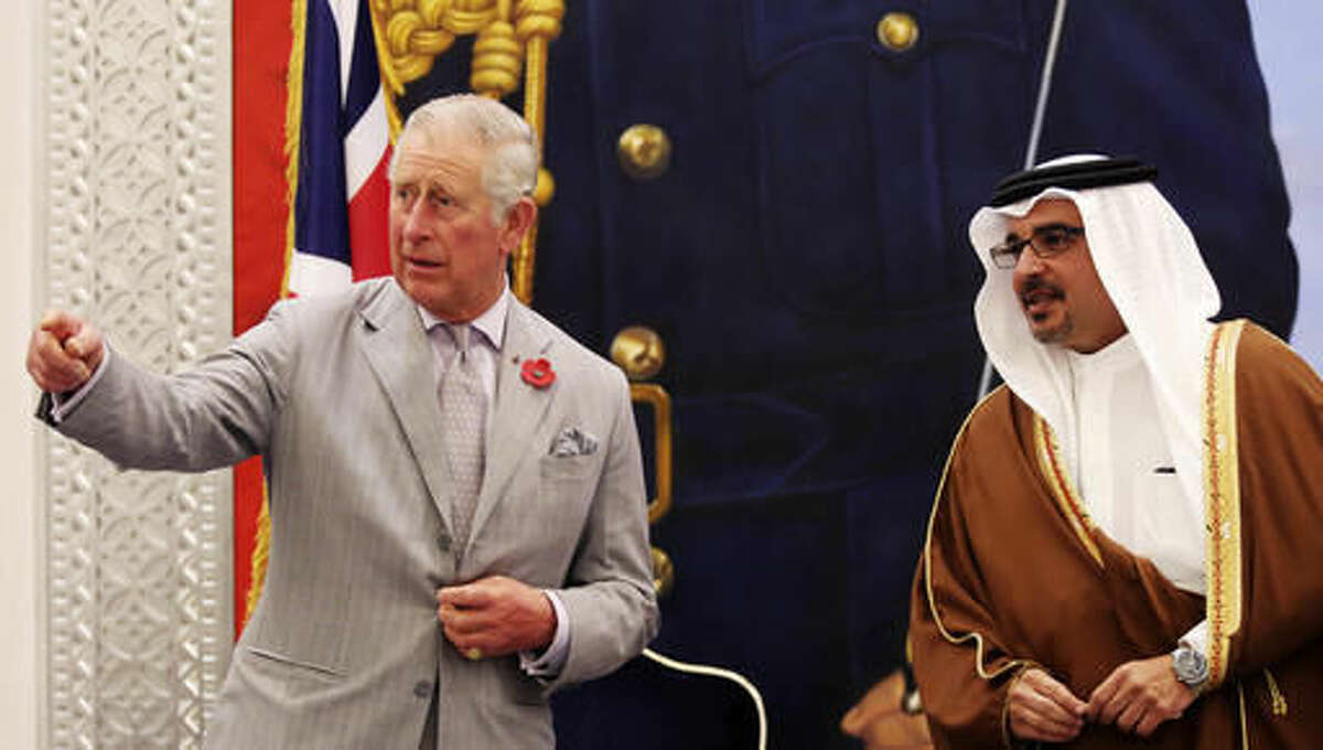 Britain's Prince Charles speaks to Bahrain's Crown Prince Salman bin Hamad bin Isa Al Khalifa upon arriving to Manama, Bahrain, on Tuesday, Nov. 8, 2016. Prince Charles and his wife Camilla are on a three-nation tour of the Gulf. (AP Photo/Jon Gambrell)
