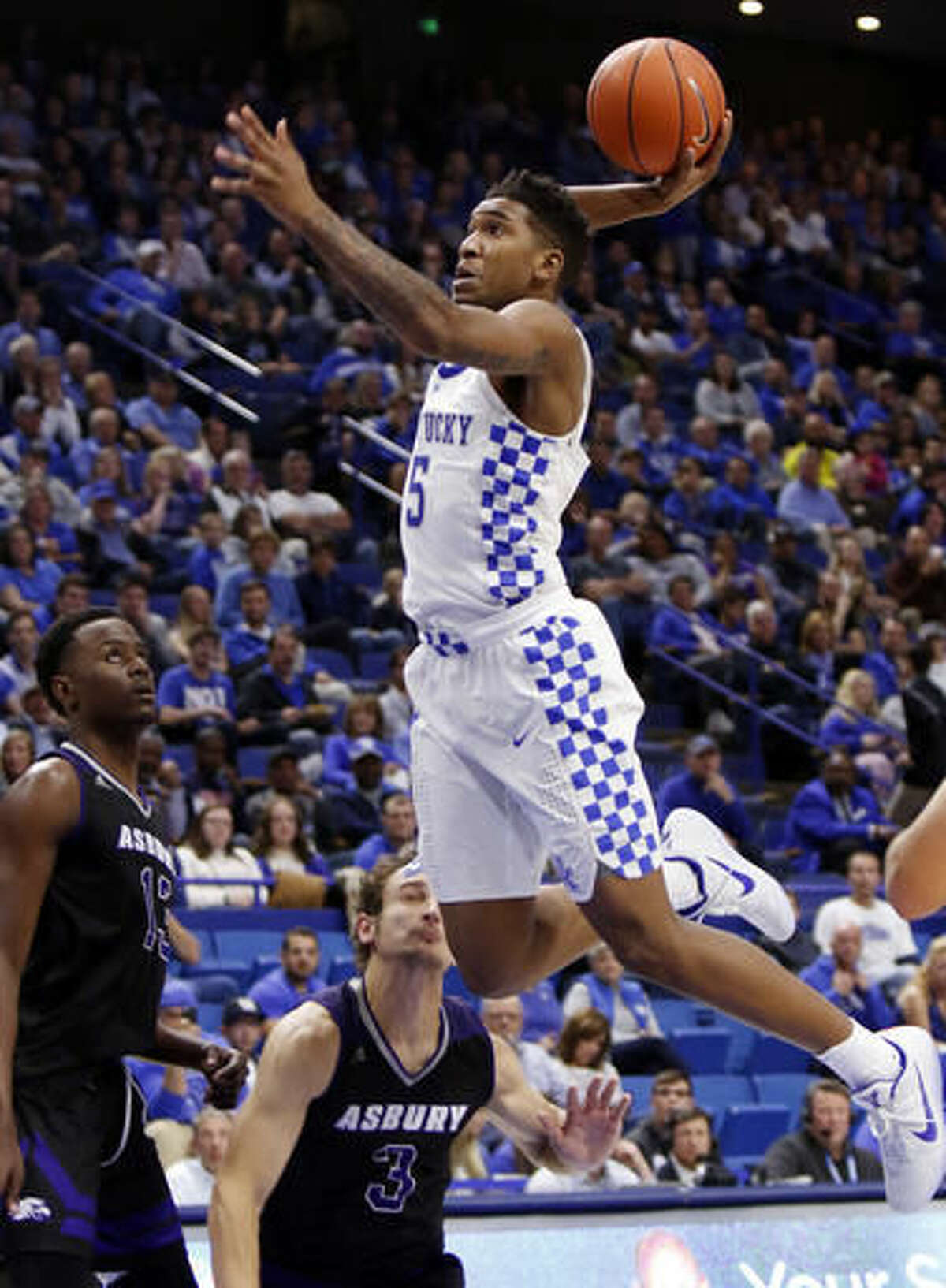 FILE - In this Nov. 6, 2016, file photo, Kentucky's Malik Monk, right, dunks near Asbury's Bushe Ramabu, left, and Daulton Peters during the second half of an NCAA college basketball exhibition game, in Lexington, Ky. Kentucky’s John Calipari landed five of the nation’s top 24 prospects according to composite rankings of recruiting websites compiled by 247Sports. The new Wildcats include guards De’Aaron Fox, Malik Monk, Bam Adebayo, Wenyen Gabriel and Sacha Killeya-Jones. (AP Photo/James Crisp, File)