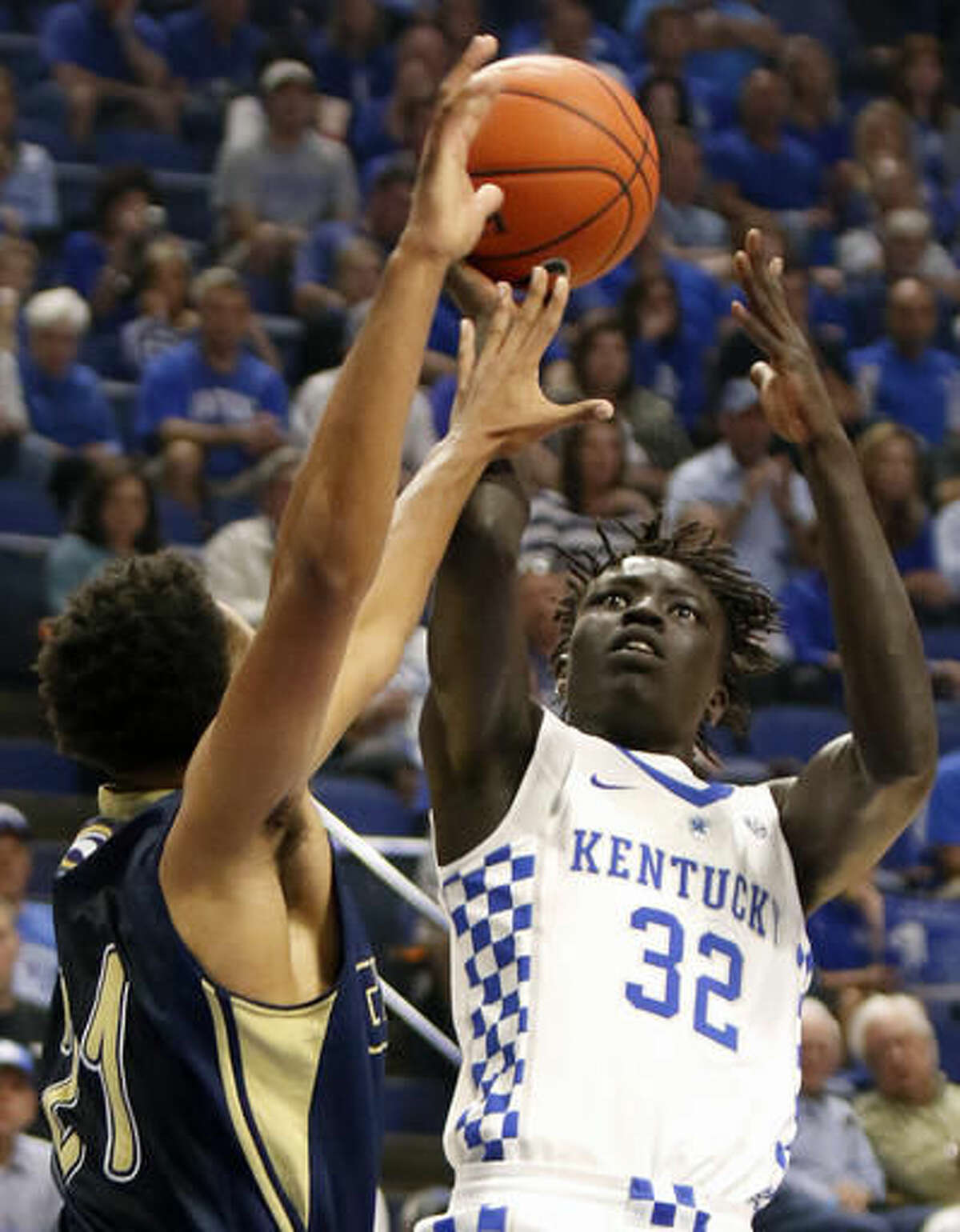 FILE - In this Oct. 30, 2016, file photo, Kentucky's Wenyen Gabriel (32) shoots while pressured by Clarion's Justin Grant during the first half of their NCAA college basketball exhibition, in Lexington, Ky. Kentucky’s John Calipari landed five of the nation’s top 24 prospects according to composite rankings of recruiting websites compiled by 247Sports. The new Wildcats include guards De’Aaron Fox, Malik Monk, Bam Adebayo, Wenyen Gabriel and Sacha Killeya-Jones. (AP Photo/James Crisp, File)