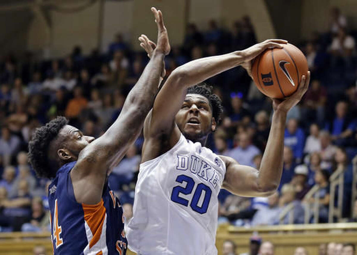 FILE - In this Oct. 28, 2016, file photo, Duke's Marques Bolden (20) is pressured by Virginia State's Amiel Terry during the first half of an exhibition NCAA college basketball game in Durham, N.C. Duke’s six-man freshman class has four of the nation’s top 15 recruits according to composite rankings of recruiting websites compiled by 247Sports. That group includes forwards Harry Giles (No. 2) and Jayson Tatum (No. 4), guard Frank Jackson (No. 13) and center Marques Bolden (No. 15). (AP Photo/Gerry Broome, File)