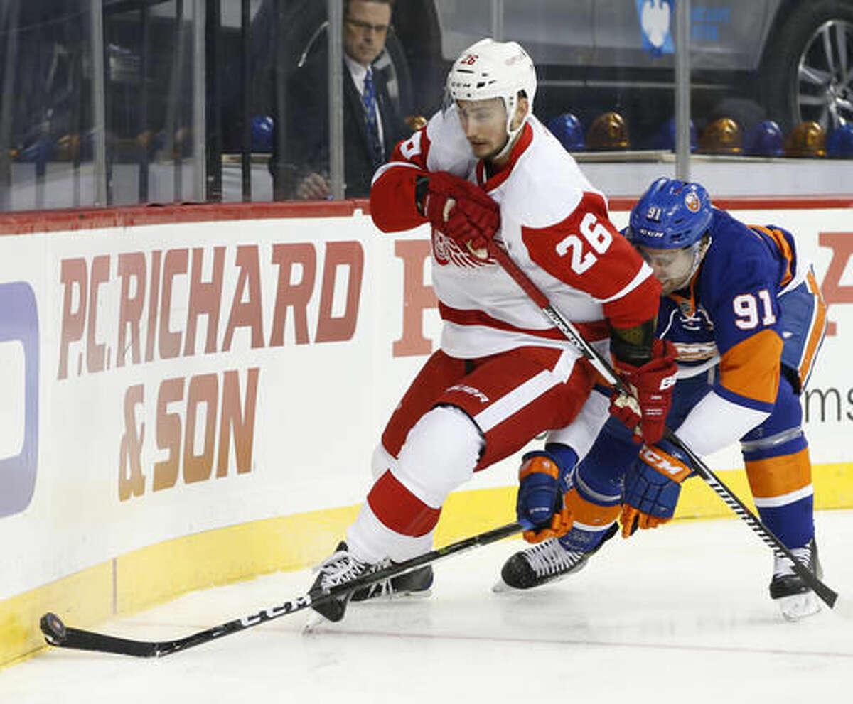 New York Islanders' center John Tavares (91) defends against Detroit Red Wings' right wing Tomas Jurco (26), of Slovakia, during the first period of an NHL hockey game, Sunday, Dec. 4, 2016, in New York. (AP Photo/Kathy Willens)