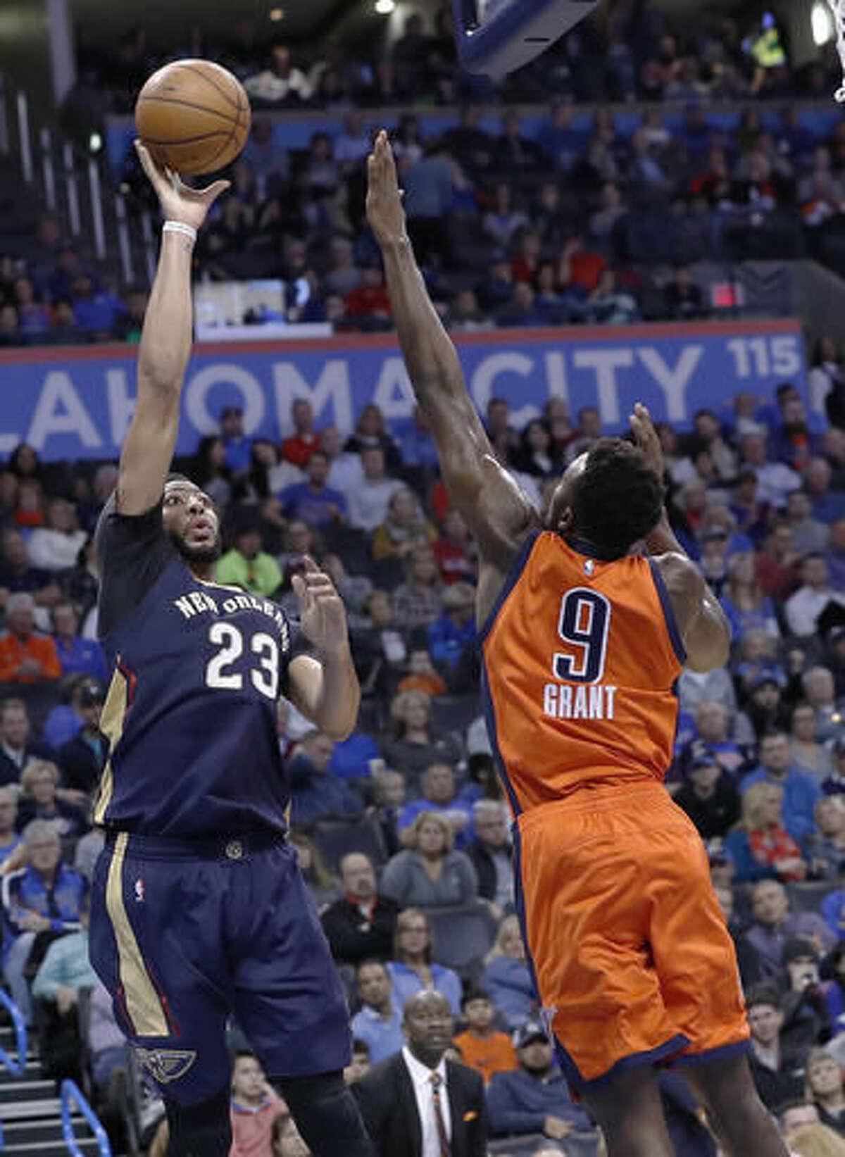 New Orleans Pelicans forward Anthony Davis (23) shoots as Oklahoma City Thunder forward Jerami Grant (9) defends during the first half of an NBA basketball game in Oklahoma City, Sunday, Dec. 4, 2016. (AP Photo/Alonzo Adams)