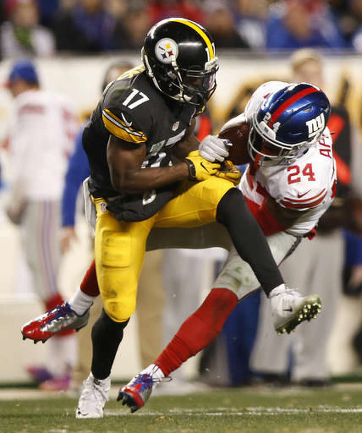 New York Giants cornerback Eli Apple (24) intercepts pass intended for Pittsburgh Steelers wide receiver Eli Rogers (17) during the second half of an NFL football game in Pittsburgh, Sunday, Dec. 4, 2016. (AP Photo/Jared Wickerham)