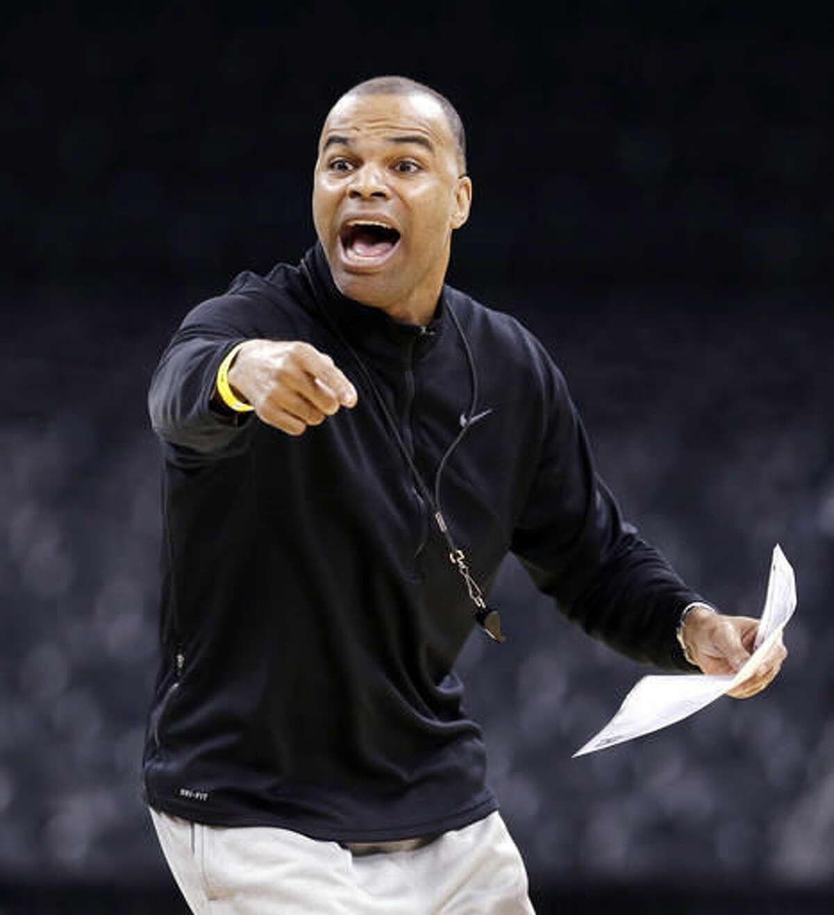 FILE - In this Wednesday, March 19, 2014, file photo Harvard men's basketball coach Tommy Amaker directs his team during practice for the NCAA college basketball tournament in Spokane, Wash. Harvard will be playing Stanford in China on Saturday afternoon. (AP Photo/Elaine Thompson)