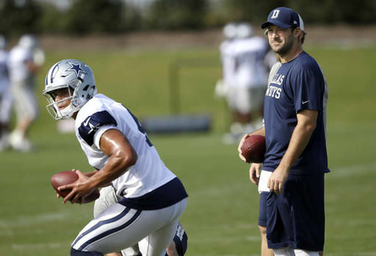 FILE - In this Oct. 26, 2016, file photo, Dallas Cowboys quarterback Tony Romo looks on as fellow quarterback Dak Prescott runs a drill during football practice at the team's practice facility in Frisco, Texas. Romo is running the scout team in practice even though Dallas' starting quarterback the past 10 years looks ready to return from a back injury. (AP Photo/LM Otero, File)