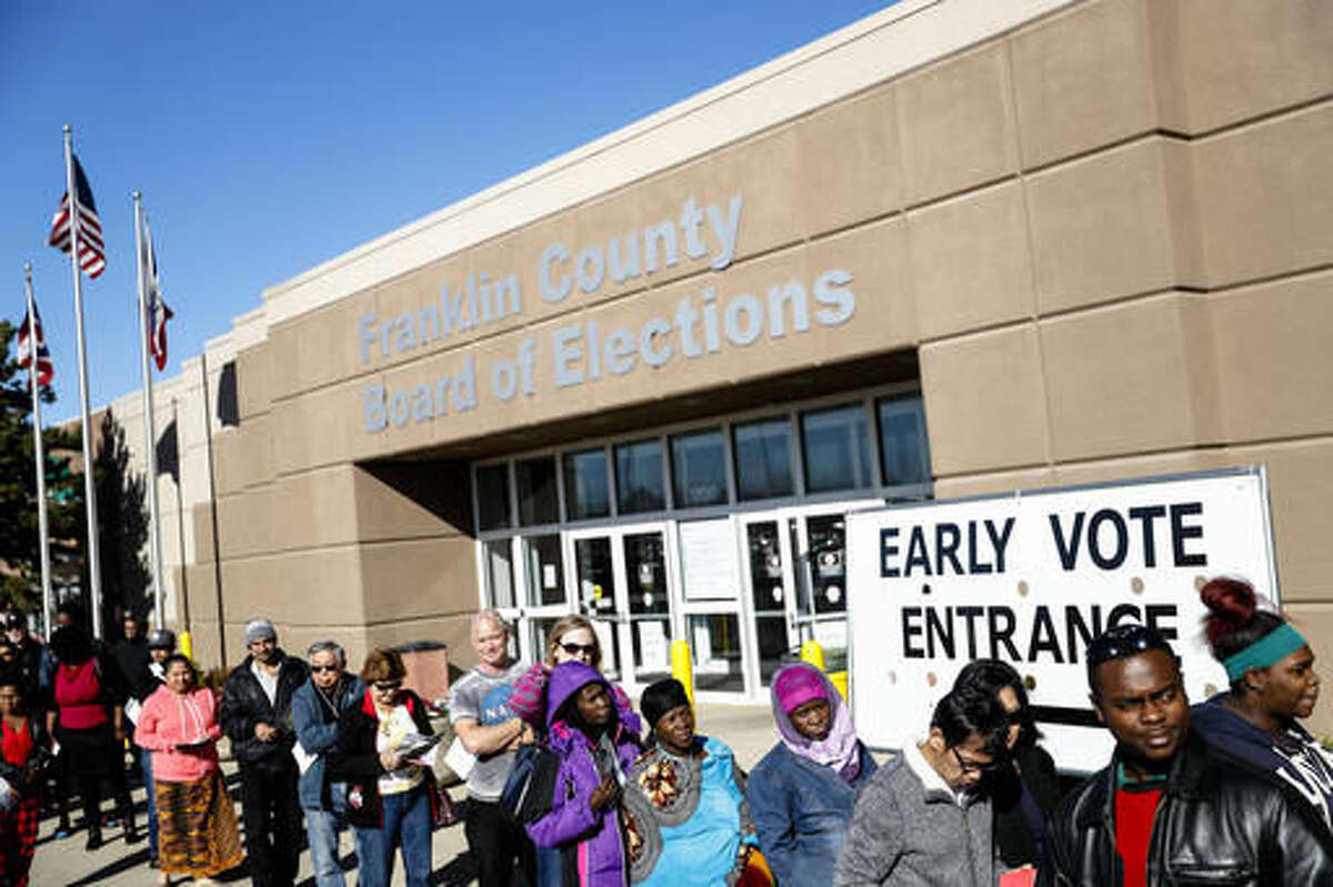 A line of early voters waits outside the Franklin County Board of Elections, Monday, Nov. 7, 2016, in Columbus, Ohio. Heavy turnout has caused long lines as voters take advantage of their last opportunity to vote before election day. (AP Photo/John Minchillo)