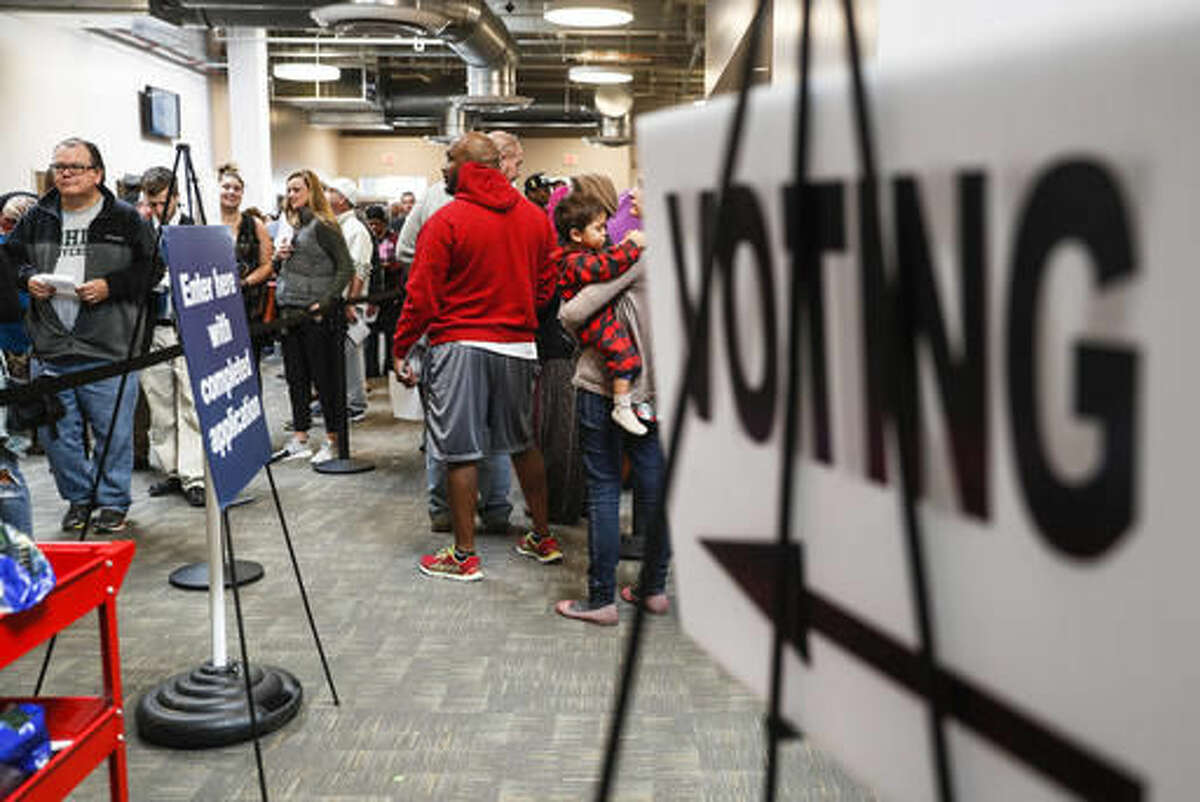 A line of early voters wait in queue at the Franklin County Board of Elections, Monday, Nov. 7, 2016, in Columbus, Ohio. Heavy turnout has caused long lines as voters take advantage of their last opportunity to vote before election day. (AP Photo/John Minchillo)
