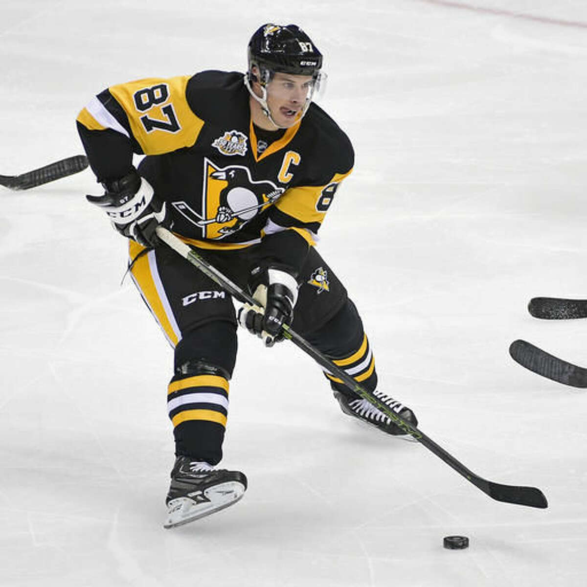 FILE - In this Oct. 27, 2016, file photo, Pittsburgh Penguins center Sidney Crosby (87) skates with the puck during an NHL hockey game against the New York Islanders on Thursday, Oct. 27, 2016, in Pittsburgh. Connor McDavid grew up idolizing Sidney Crosby. Now the Edmonton Oilers young star gets a chance to face Crosby in the NHL for the first time on Tuesday. Nov. 8, 2016 when the Oilers visit the Pittsburgh Penguins. (AP Photo/Fred Vuich, File)