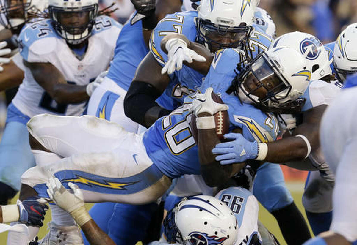 San Diego Chargers running back Melvin Gordon, center, is upended during the second half of an NFL football game against the Tennessee Titans, Sunday, Nov. 6, 2016, in San Diego. (AP Photo/Rick Scuteri)
