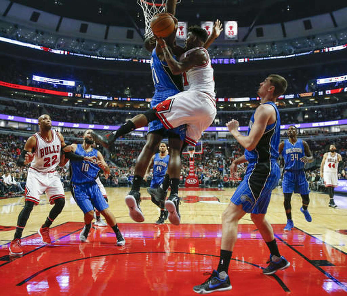 Chicago Bulls guard Jimmy Butler, right, goes to the basket against Orlando Magic center Bismack Biyombo, left, during the first half of an NBA basketball game, Monday, Nov. 7, 2016, in Chicago. (AP Photo/Kamil Krzaczynski)
