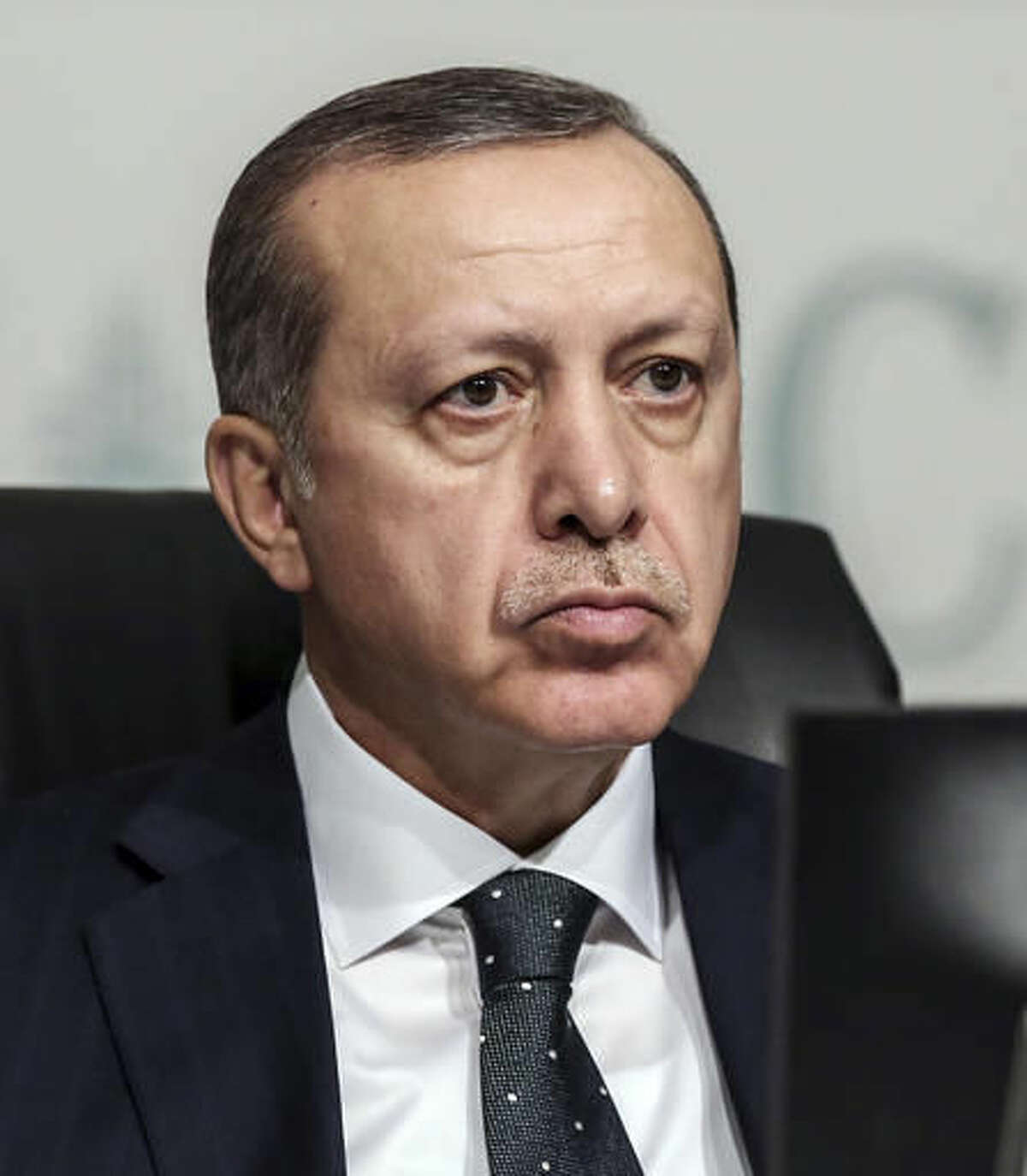 Turkey's President Recep Tayyip Erdogan listens as he attends an annual economy and trade meeting of the Organization for Islamic Cooperation in Istanbul, Wednesday, Nov. 23, 2016. Erdogan declared Wednesday that an upcoming vote in the European Parliament on whether to freeze membership talks with Turkey is of "no value" to his country. (Yasin Bulbul, Presidential Press Service,/Pool Photo via AP)