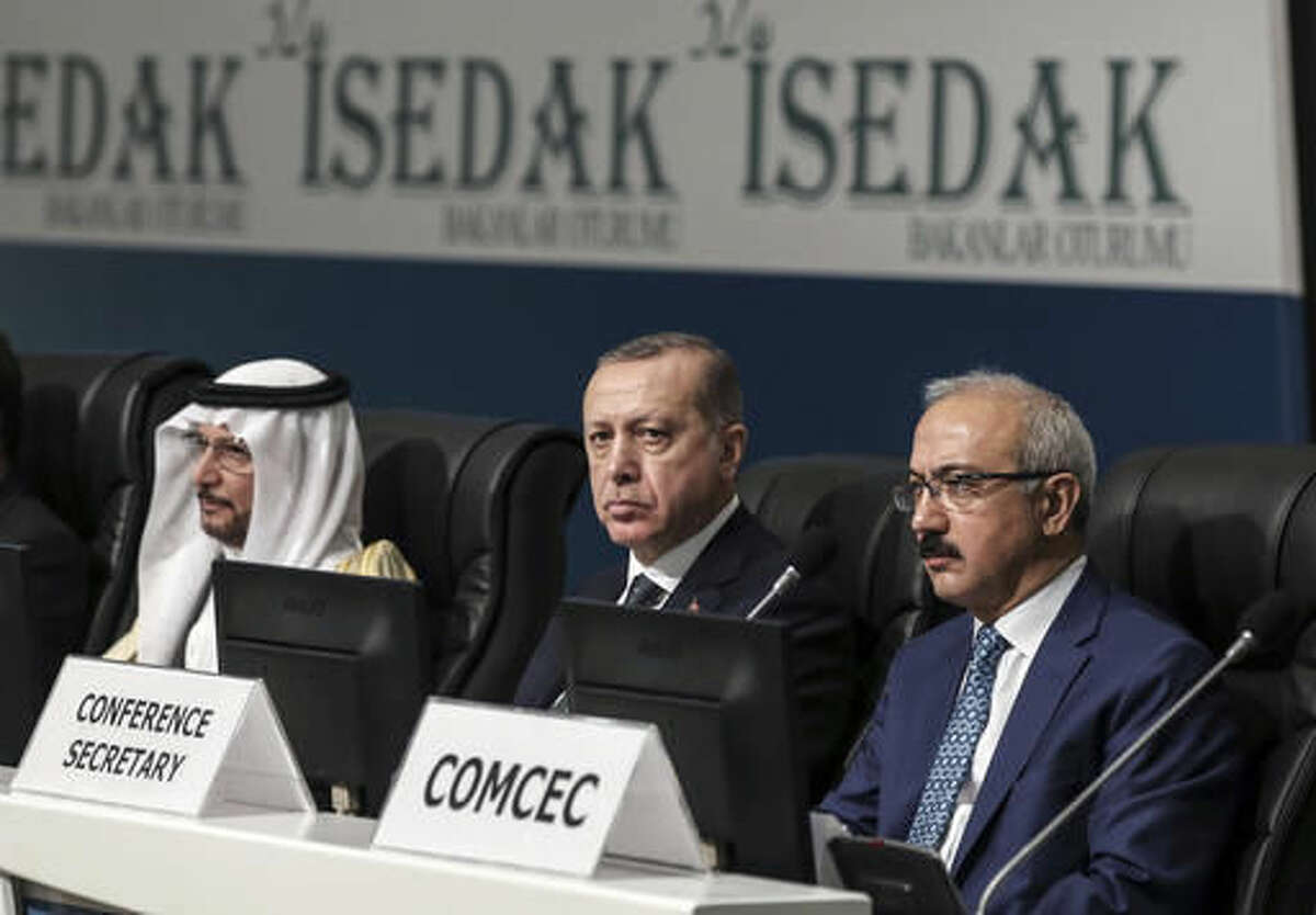 Turkey's President Recep Tayyip Erdogan, center, listens as he attends an annual economy and trade meeting of the Organization for Islamic Cooperation in Istanbul, Wednesday, Nov. 23, 2016. Erdogan declared Wednesday that an upcoming vote in the European Parliament on whether to freeze membership talks with Turkey is of "no value" to his country. (Yasin Bulbul, Presidential Press Service/ Pool Photo via AP)