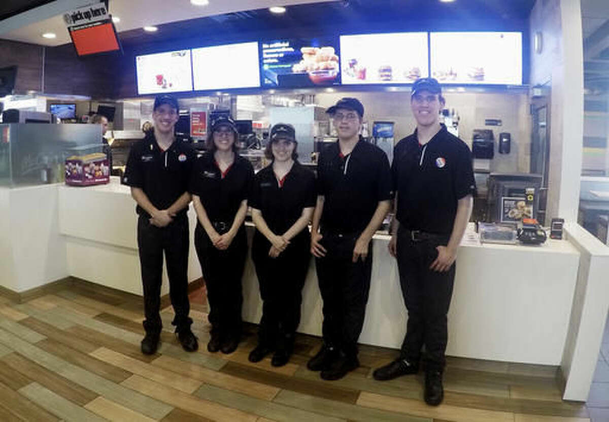 In this Oct. 6, 2016 photo, Lucas, Lauren, Lindsey, Leith and Logan Curtis, left to right, pose in the lobby of a McDonald's in Potterville, Mich. The 18-year-old non-identical quintuplets all work at the Lansing-area restaurant. (AP Photo/Mike Householder)