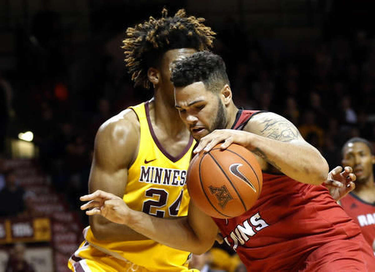 Louisiana Lafayette's Justin Miller, right, drives by Minnesota's Eric Curry in the first half of an NCAA college basketball game Friday, Nov. 11, 2016, in Minneapolis. (AP Photo/Jim Mone)