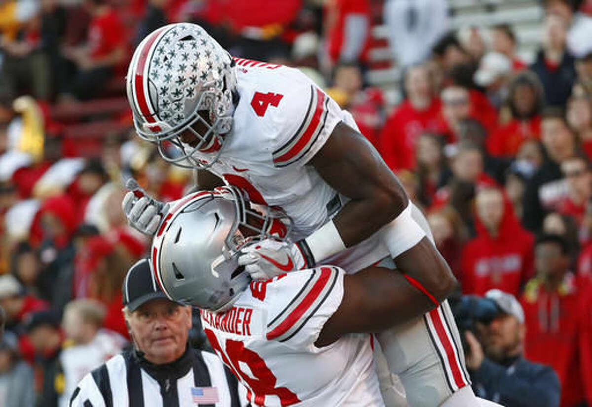 Ohio State running back Curtis Samuel, top, celebrates his touchdown with teammate A.J. Alexander in the first half of an NCAA college football game against Maryland in College Park, Md., Saturday, Nov. 12, 2016. (AP Photo/Patrick Semansky)