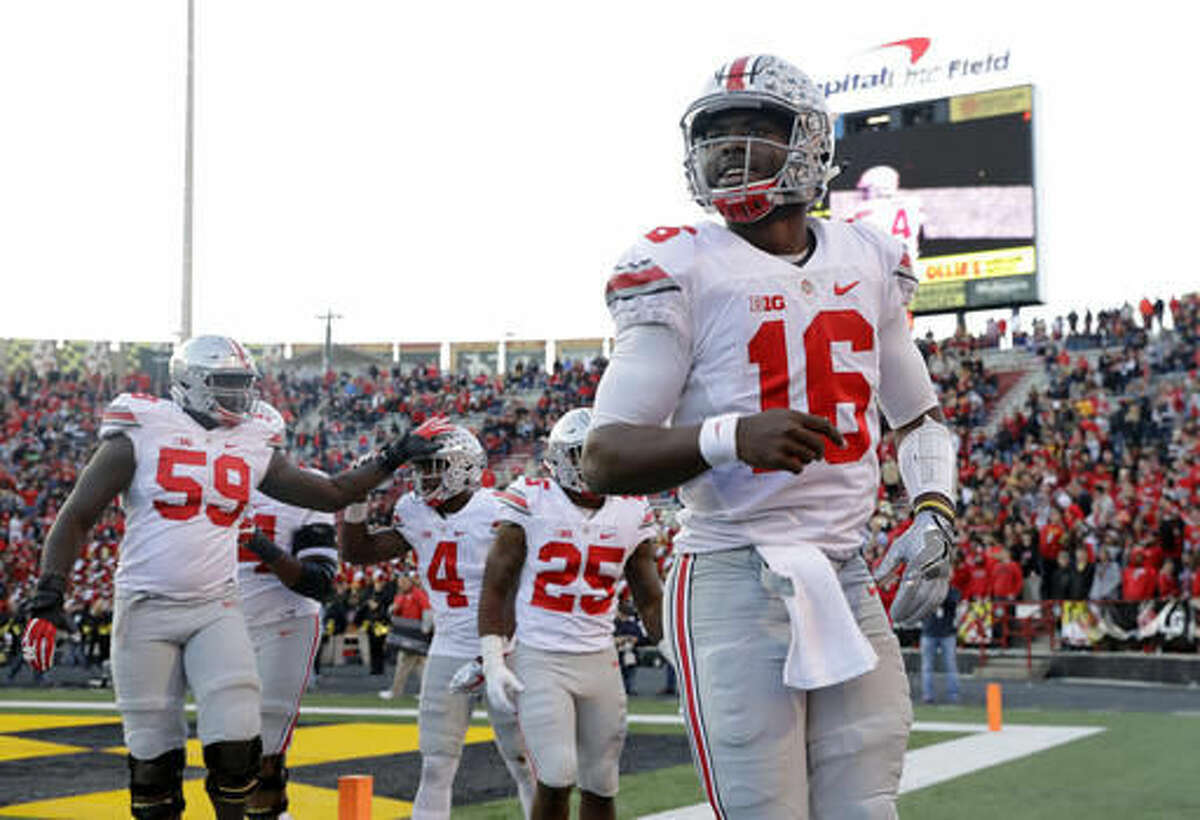 Ohio State quarterback J.T. Barrett (16) celebrates after throwing a touchdown pass to running back Curtis Samuel (4) in the first half of an NCAA college football game against Maryland in College Park, Md., Saturday, Nov. 12, 2016. (AP Photo/Patrick Semansky)