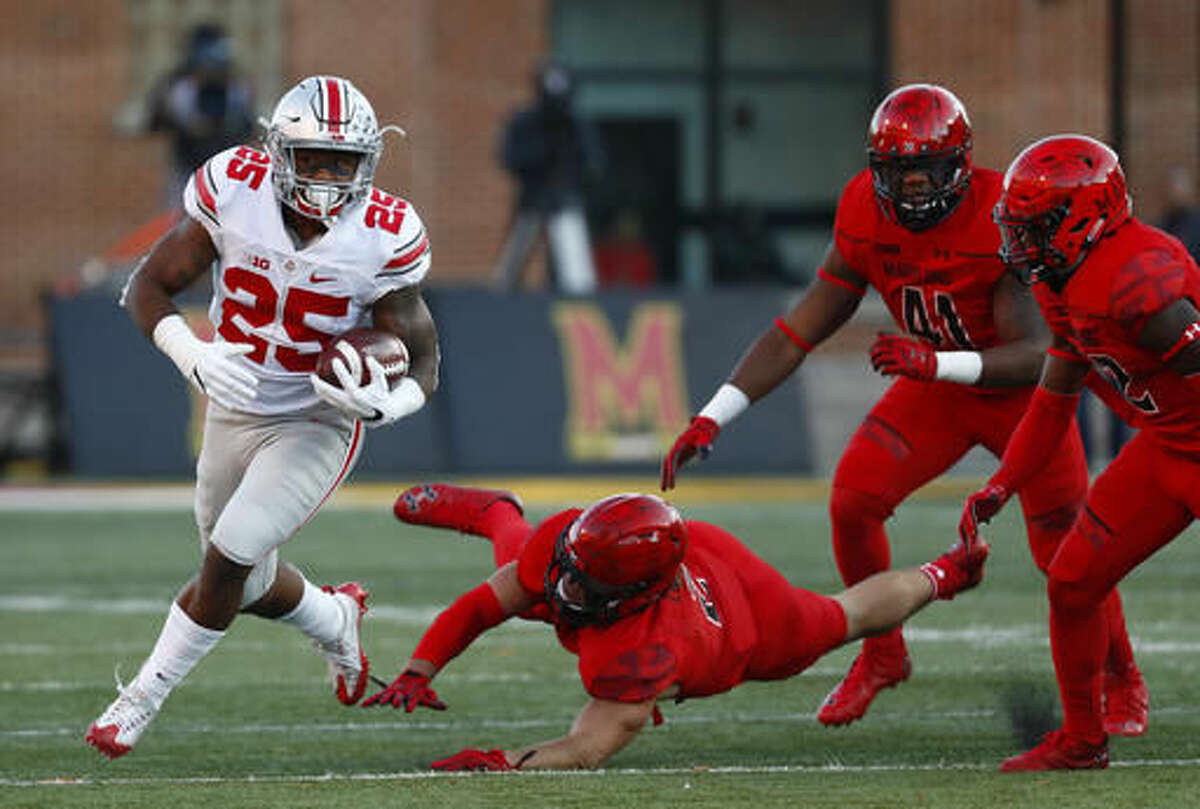 Ohio State running back Mike Weber (25) rushes past a pack of Maryland defenders in the first half of an NCAA college football game in College Park, Md., Saturday, Nov. 12, 2016. (AP Photo/Patrick Semansky)