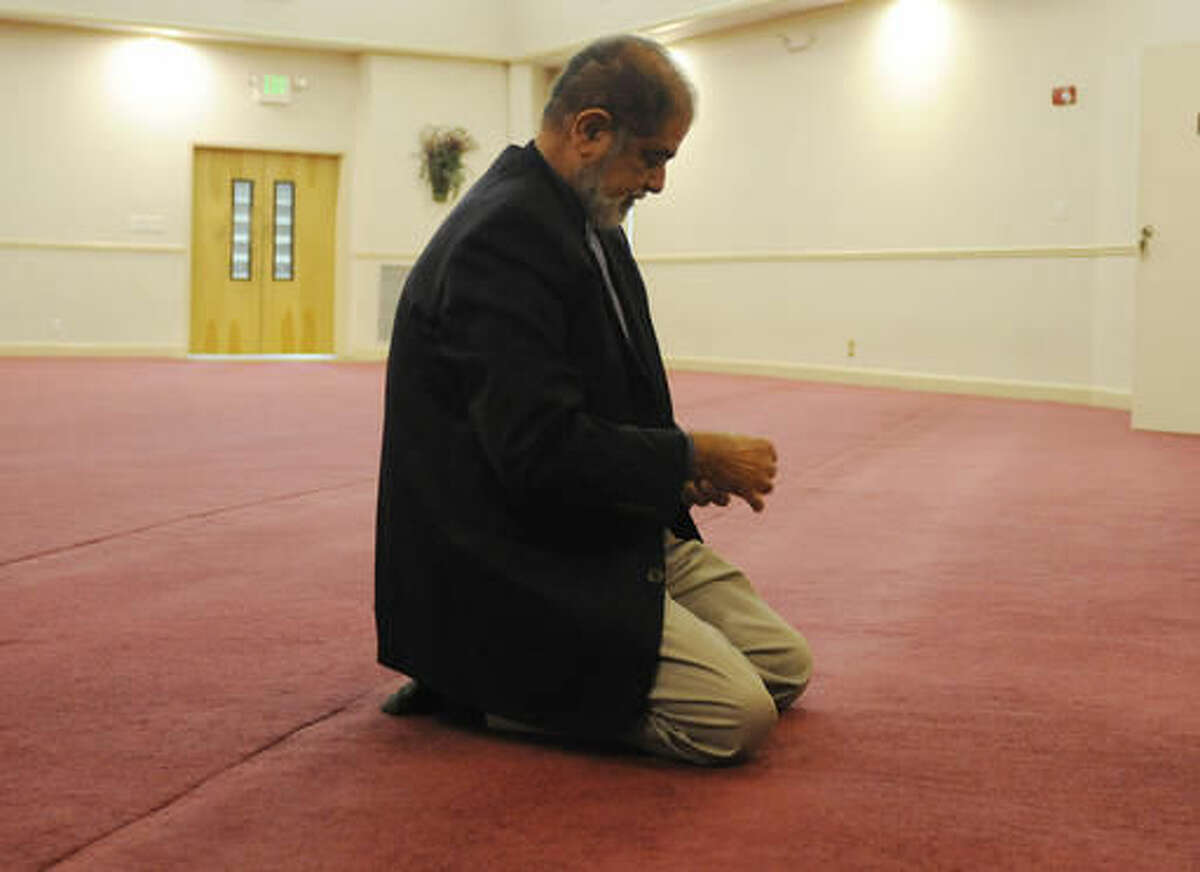 FILE - In this Wednesday, Nov. 9, 2016 file photo, Ashfaq Taufique, president of the Birmingham Islamic Society, kneels in prayer at the group's mosque in Hoover, Ala. Following the election of Donald Trump, Taufique said some members are worried because of his campaign rhetoric concerning Muslims. (AP Photo/Jay Reeves)