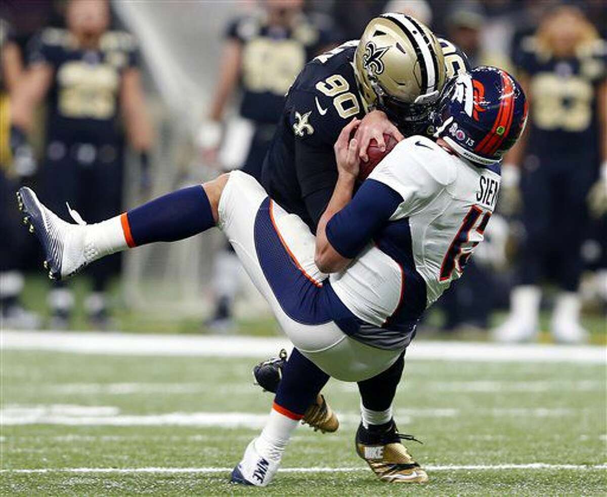 Denver Broncos quarterback Trevor Siemian (13) is sacked by New Orleans Saints defensive tackle Nick Fairley (90) in the first half of an NFL football game in New Orleans, Sunday, Nov. 13, 2016. (AP Photo/Butch Dill)
