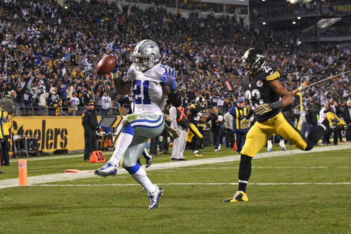 Dallas Cowboys running back Ezekiel Elliott (21) dances into the end zone ahead of Pittsburgh Steelers free safety Mike Mitchell (23) for a game-winning touchdown during the second half of an NFL football game in Pittsburgh, Sunday, Nov. 13, 2016. The Cowboys won 35-30. (AP Photo/Don Wright)