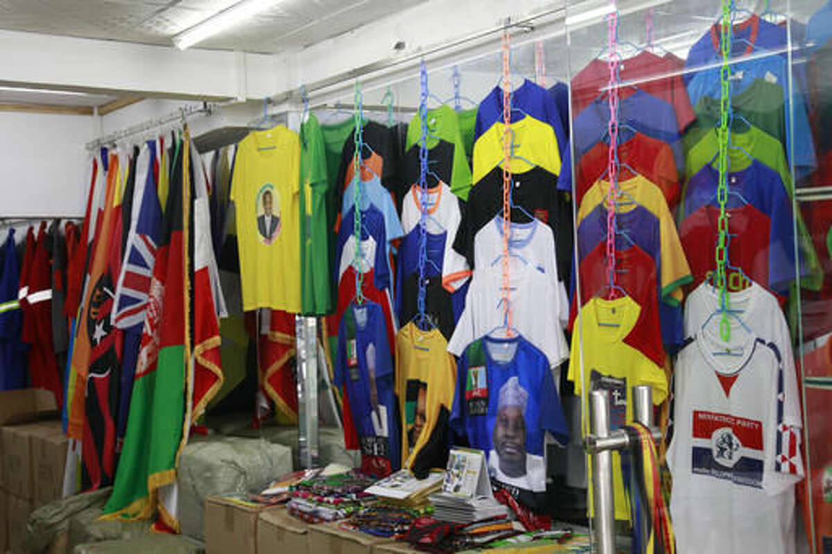 In this Thursday, Aug. 11, 2016, photo, a shop sells t-shirts catering to the local African communities in Guangzhou in southern China's Guangdong province.  (AP Photo/Louise Watt)