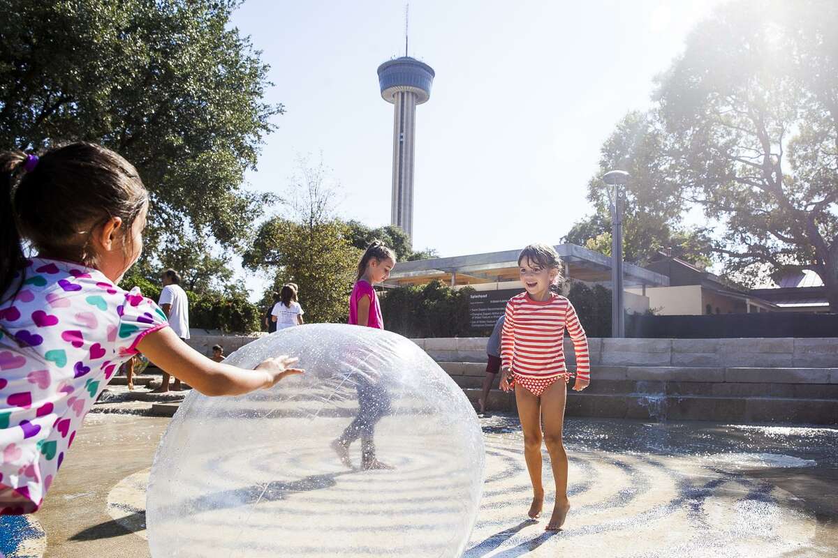 Sofia Haynes, 9, (center) plays in the "Splash Pad" at the opening ceremony of Yanaguana Garden Oct. 3, 2015, at Hemisfair Park. Yanaguana Garden is the first of three phases in Hemisfair’s relaunch expected to open in the next few years.