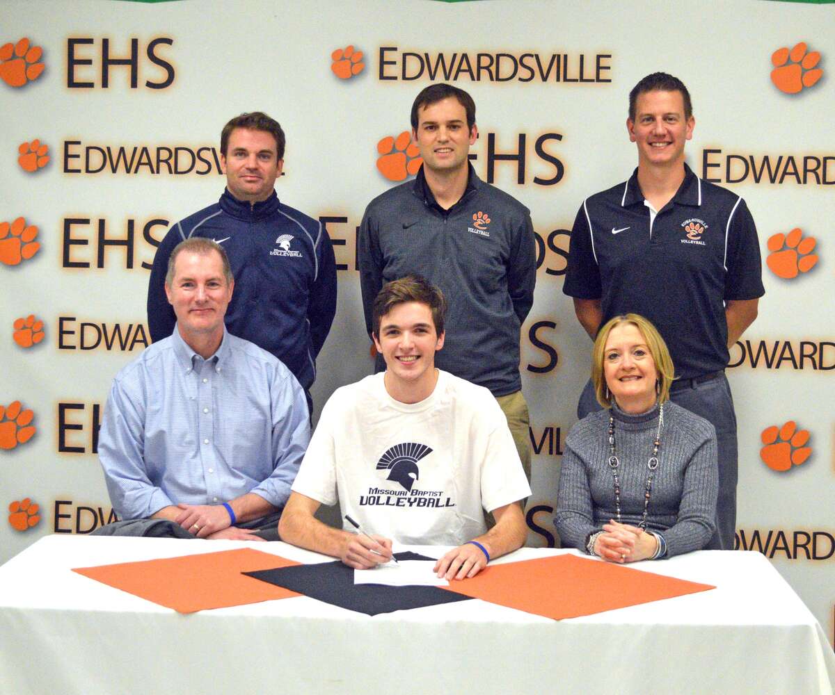 Edwardsville senior Jack Grimm, seated center, signed to play volleyball at Missouri Baptist University. Looking on in the front row are his father, Mike Grimm, seated left, and mother, Trudy Grimm. In the back row, left to right, are MBU coach John Yehling, EHS head coach Andy Bersett and EHS assistant coach Scott Smith.