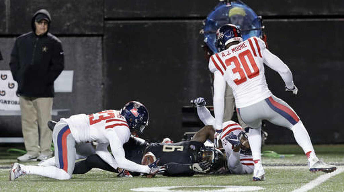 Mississippi's Carlos Davis (23) recovers a fumbled punt by Vanderbilt's Darrius Sims (6) in the first half of an NCAA college football game Saturday, Nov. 19, 2016, in Nashville, Tenn. (AP Photo/Mark Humphrey)