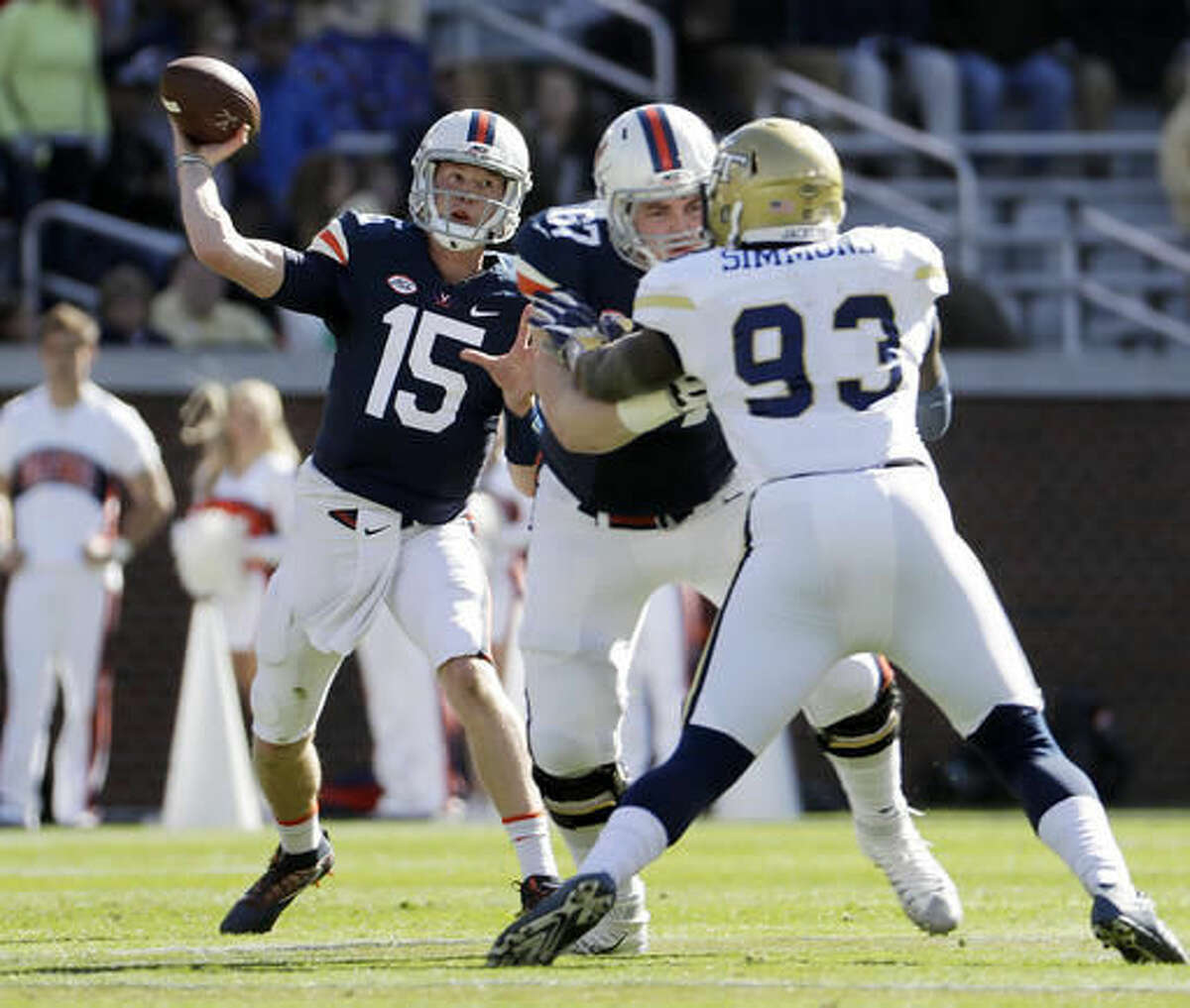 Virginia quarterback Matt Johns, left, throws a pass in the first quarter of an NCAA college football game against Georgia Tech in Atlanta, Saturday, Nov. 19, 2016. (AP Photo/David Goldman)